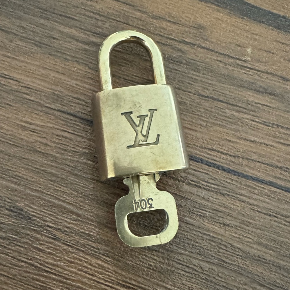 Louis Vuitton lock with key.